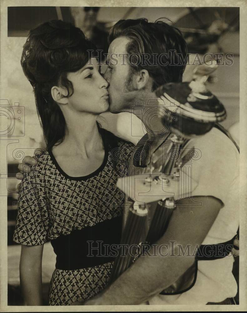 Load image into Gallery viewer, 1974 Press Photo Man holding trophy receives kiss at Pirogue race - noc12661
