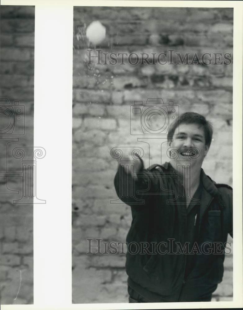 1988 Press Photo Eric Evans tosses snowmaker "snowball." - noc20477