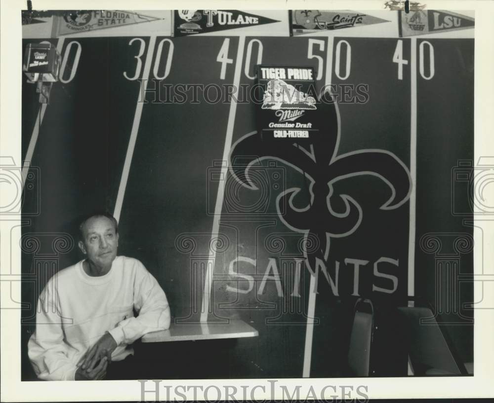 1989 Press Photo Nick Revon in "Coaches Corner" with football field wall.