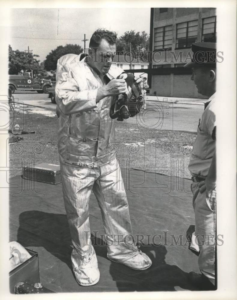 Load image into Gallery viewer, 1961 Press Photo Lt. Henry Engelbract puts oxygen mask &amp; Jack Kieffer looks on
