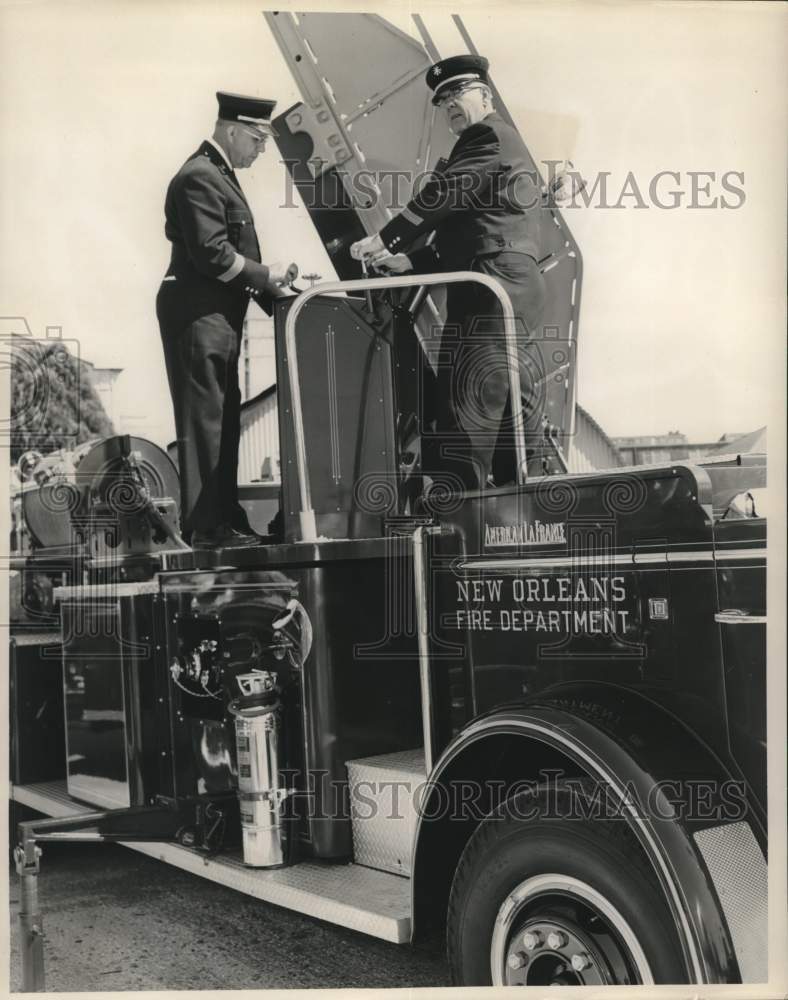 Load image into Gallery viewer, 1961 Press Photo New Orleans Fire Department firemen stand on fire engine
