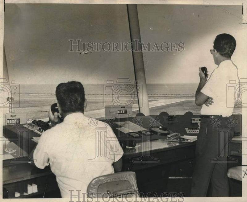 Load image into Gallery viewer, 1966 Press Photo Lakefront Airport controllers I. Delgado and Ronald Livaudais

