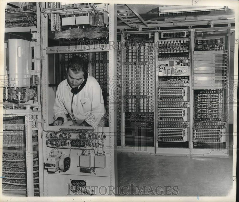 Load image into Gallery viewer, 1957 Press Photo E.J. Dupuy, Jr. checks communication equipment in New Orleans
