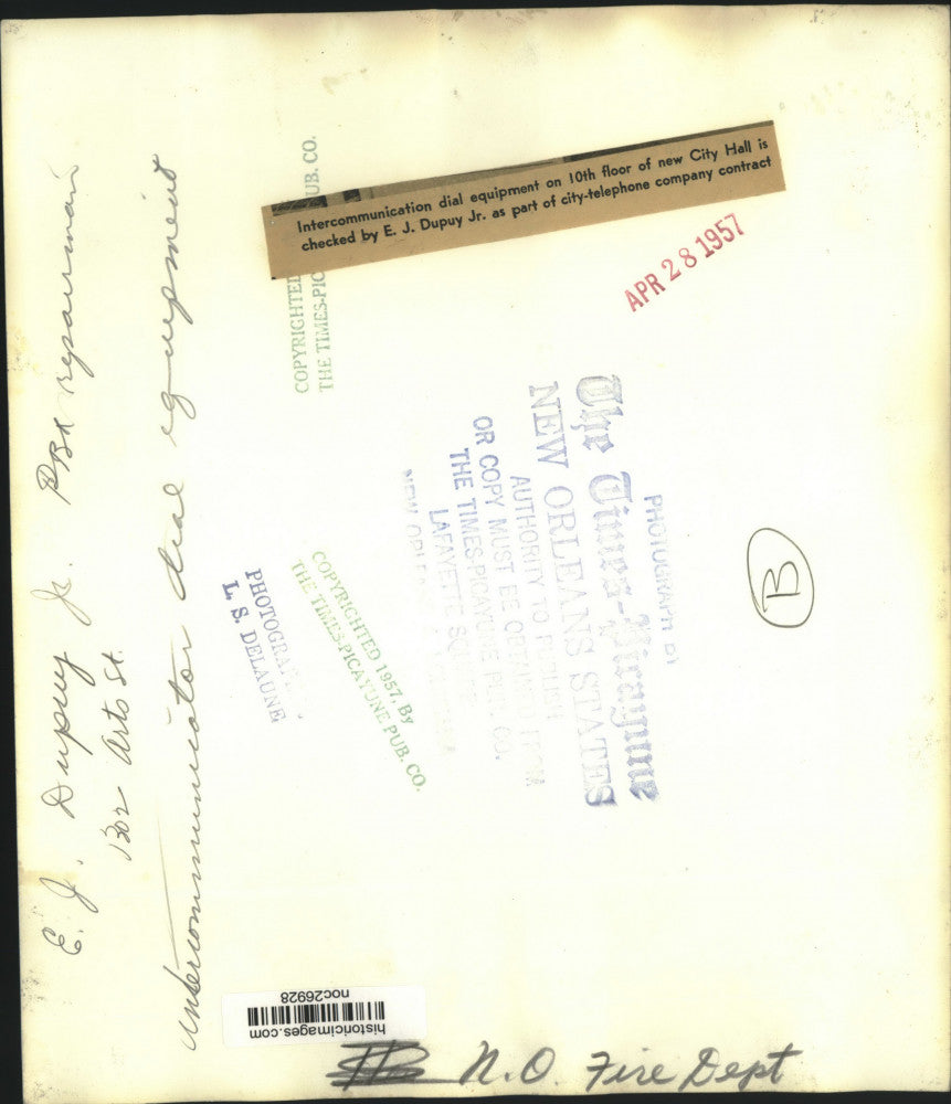 1957 Press Photo E.J. Dupuy, Jr. checks communication equipment in New Orleans