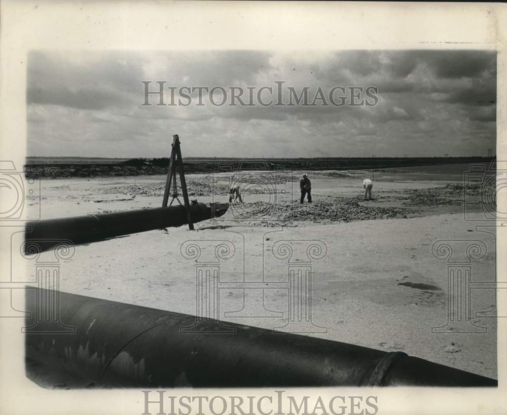1960 Press Photo Boatriders pick up shells along Highway 10 roadbed, Paris Road