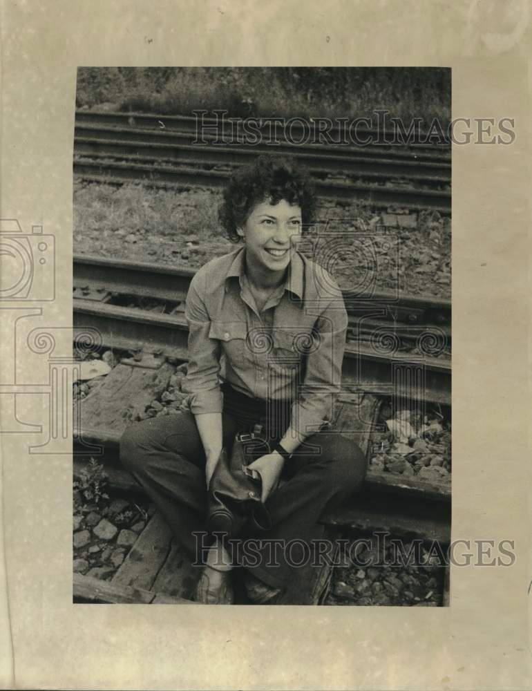Load image into Gallery viewer, 1977 Press Photo Kira smiles from the tracks of the Siberian Railroad
