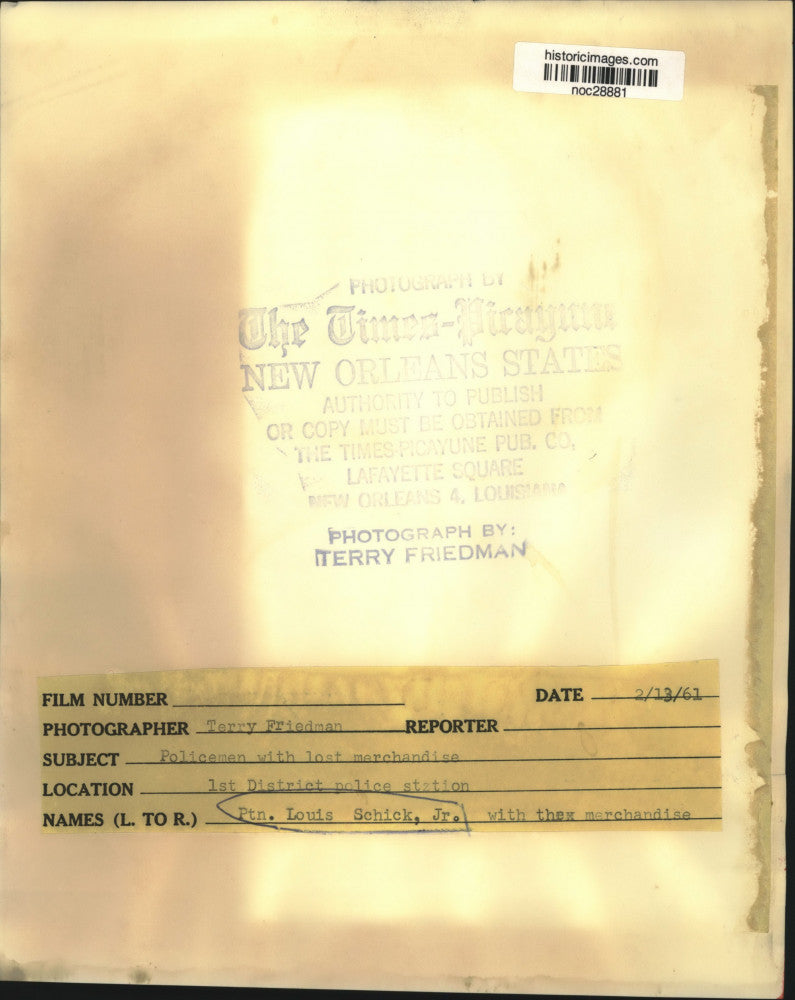 1961 Press Photo Patrolman Louis Schick Jr. with recovered stolen merchandise