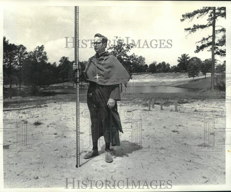 Load image into Gallery viewer, 1976 Press Photo Friar looks over site of new St. Michael's School in Picayune
