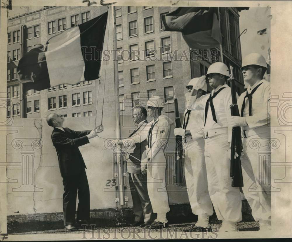 1961 Press Photo Belgian Ambassador Louis Scheyven Raises Flag, Trade Mart Roof