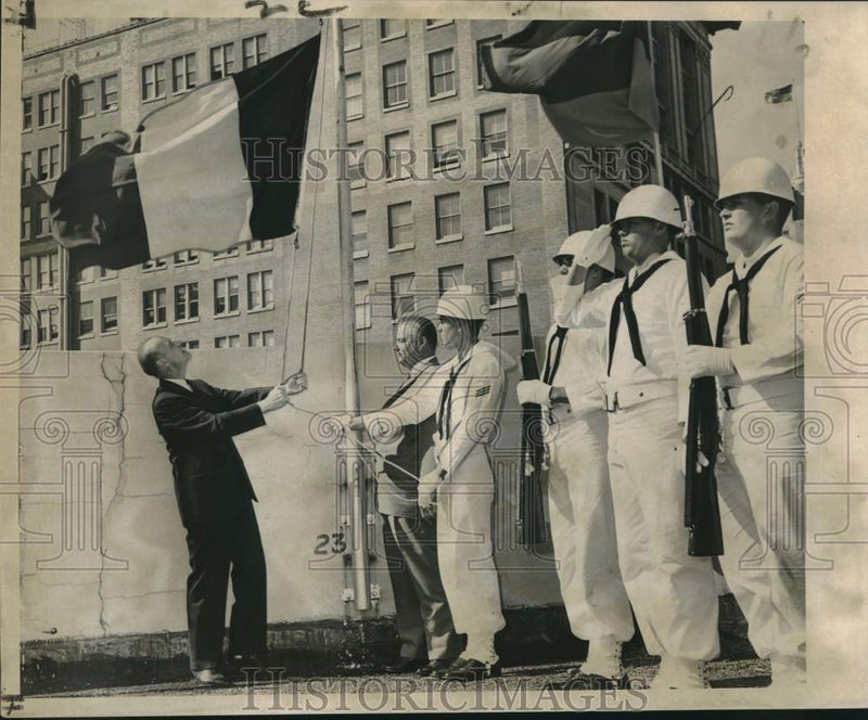 Load image into Gallery viewer, 1961 Press Photo Belgian Ambassador Louis Scheyven Raises Flag, Trade Mart Roof
