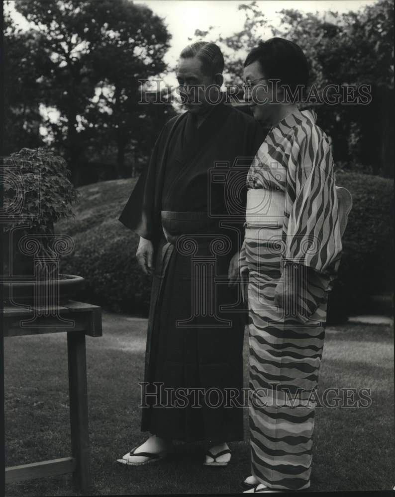 Load image into Gallery viewer, 1967 Press Photo Prime Minister and Mrs. Sato tend bonsai trees in Tokyo garden
