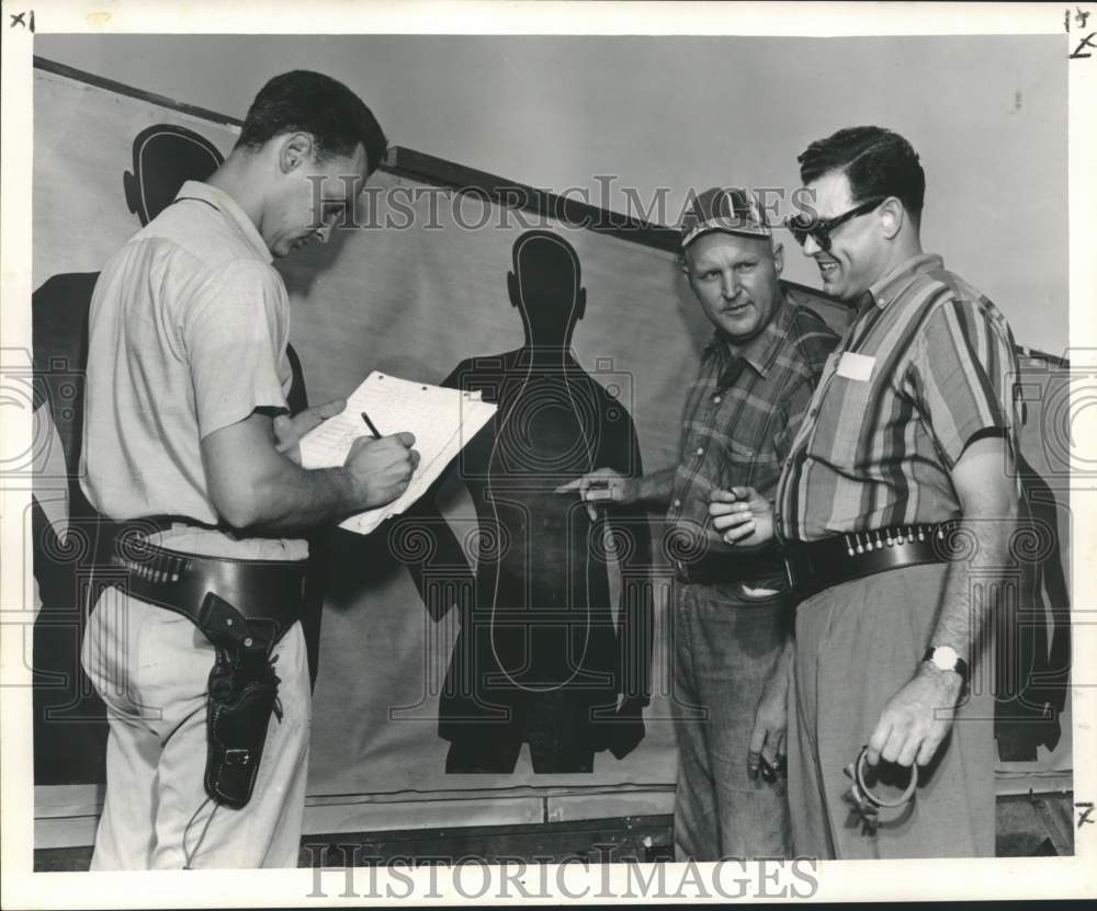 1958 Press Photo Patrolman Arthur Arnold checks Nick Macheca&#39;s Shooting Score