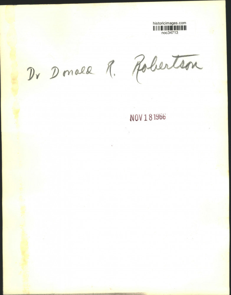 1966 Press Photo Dr. Donald R. Robertson views pamphlet - noc34713