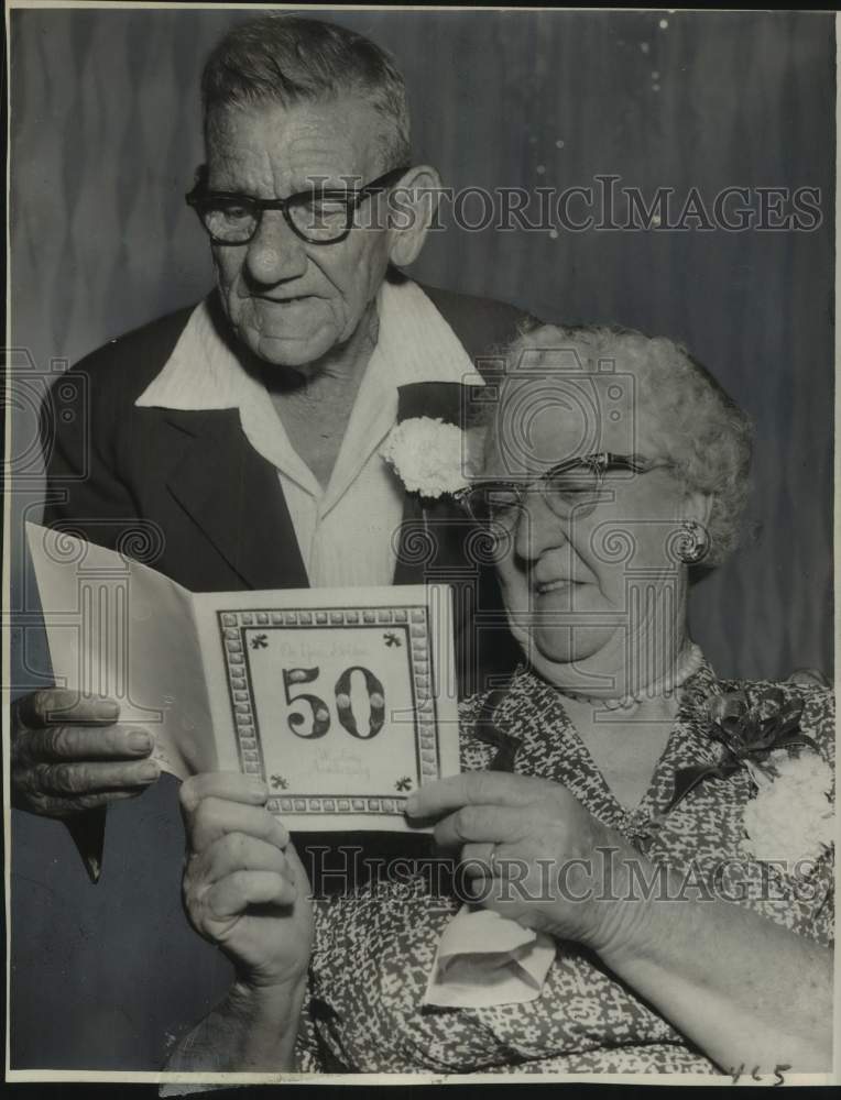 Load image into Gallery viewer, 1962 Press Photo Mr. and Mrs. Whitney Sanchez read 50th anniversary card
