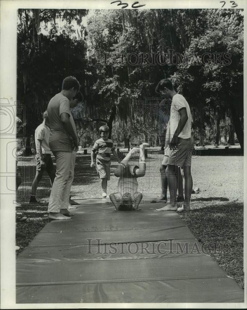 Press Photo Kid tumbles outside while others watch at YMCA in New Orleans area- Historic Images