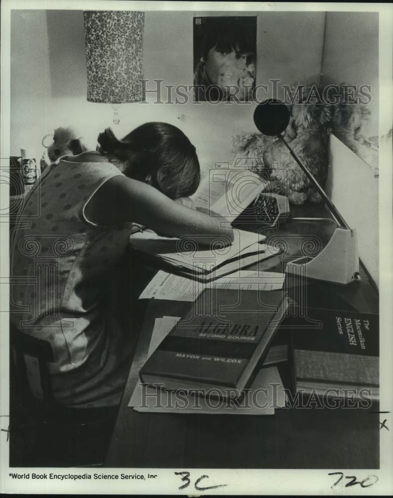 1967 Press Photo Student pours over School Textbooks at Desk - noc39796