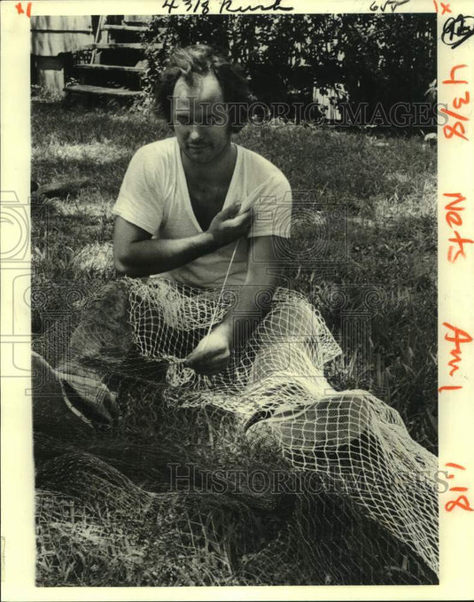 1980 Press Photo Fisherman Ricky Robin repairs net in Yscloskey, Louisiana- Historic Images