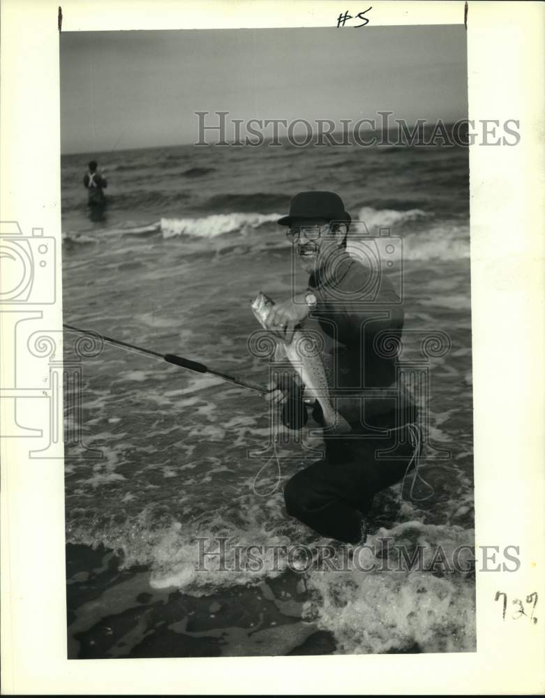 Press Photo Venture Sports fisherman shows off his large fish catch. - noc51015- Historic Images