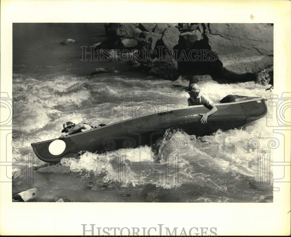 Press Photo Venture Sports-Two men in canoe paddle down the river - noc51836- Historic Images