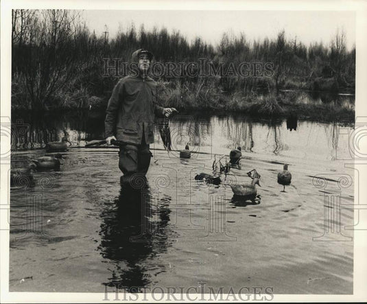 Press Photo Duck hunter holds his days' duck kill. - noc53141- Historic Images
