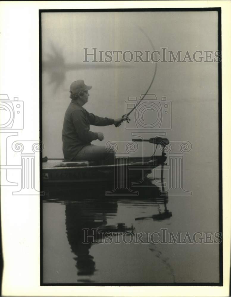 Press Photo Man Fishing from a Small Boat - noc54538- Historic Images