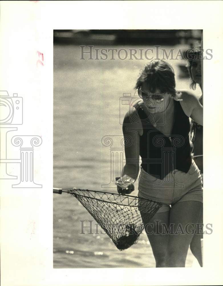 1986 Press Photo Cindy Glenn looks at religious medal given during blessing- Historic Images