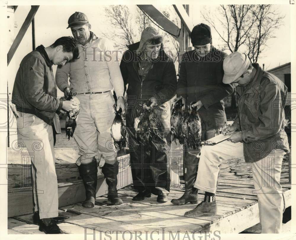 1958 Press Photo A group of Catalano waterfowl hunters logging their catch- Historic Images