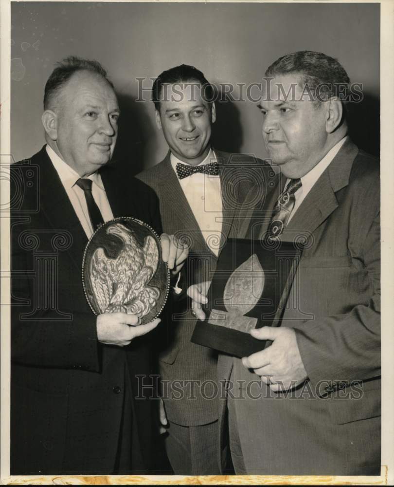 1959 Press Photo Examining Antique Firemarks on display at the Insurance Club