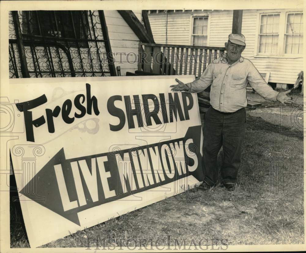 1961 Press Photo Joe Coutere displays sign at his shop in Yeloskey - noc58637- Historic Images