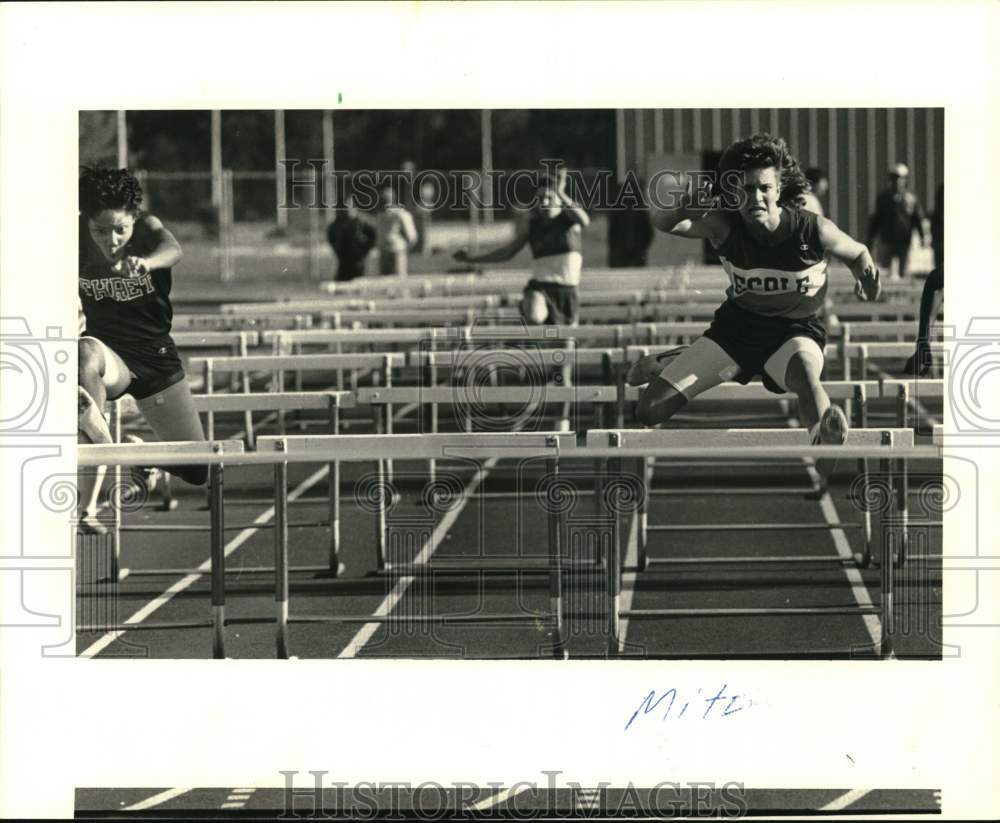 1987 Press Photo Mitzie Plaeger jumps hurdles in track meet. - noc61440- Historic Images