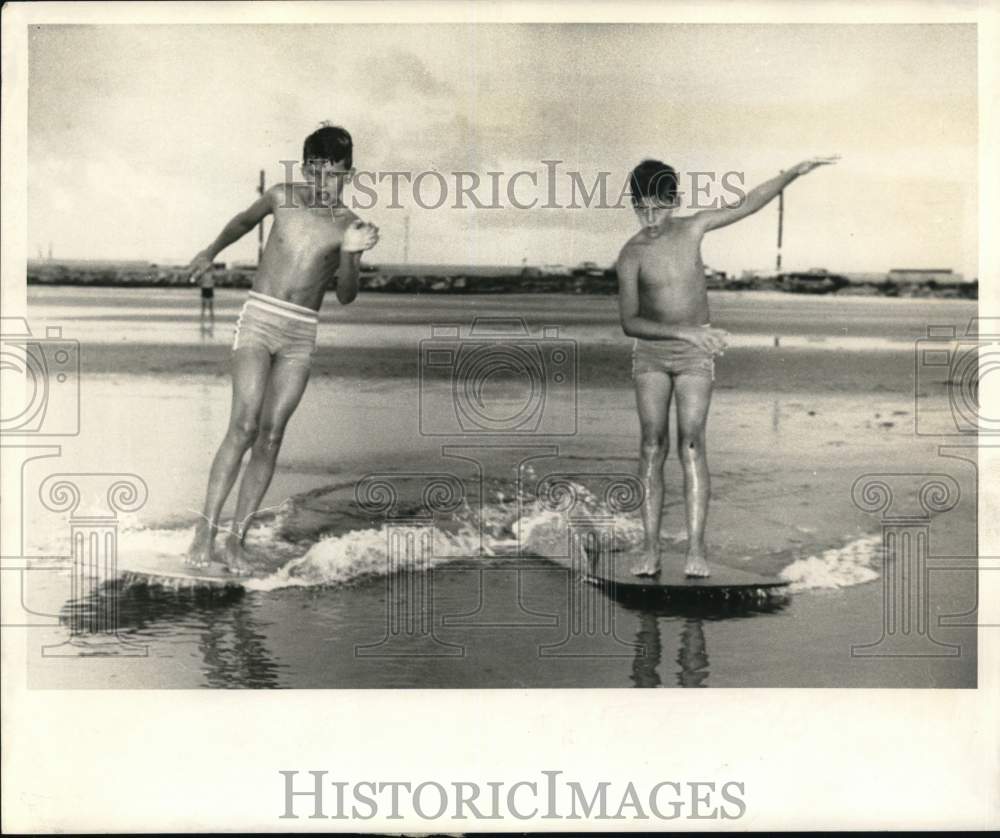 1968 Press Photo James &amp; Donald Gaddy skimming along Long Beach, Mississippi- Historic Images