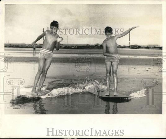 1968 Press Photo James & Donald Gaddy skimming along Long Beach, Mississippi- Historic Images