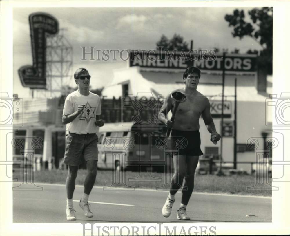 1990 Press Photo David Lozano runs Special Olympics torch down Airline Highway- Historic Images