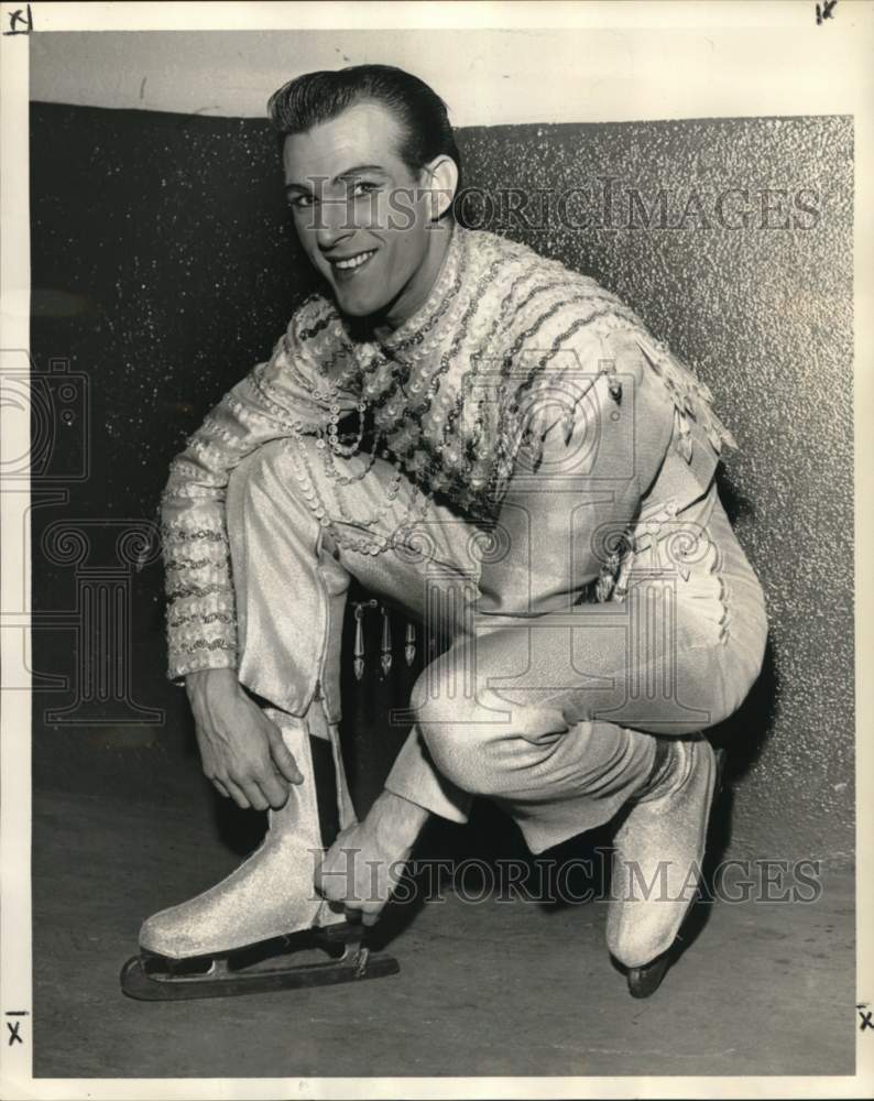 1960 Press Photo Charles Vidonne adjusts his ice skate for chorus number- Historic Images