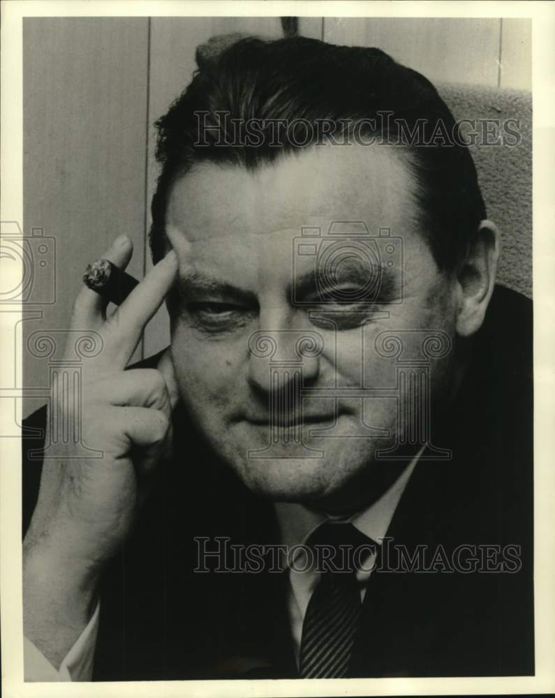 1969 Press Photo A man holding his head and cigar - noc66741