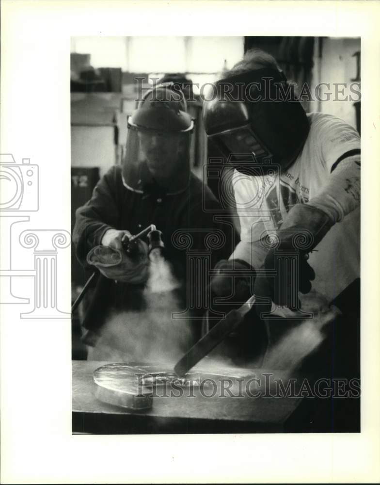 Load image into Gallery viewer, 1995 Press Photo Student heats molded glass as Professor Gene Koss turns it
