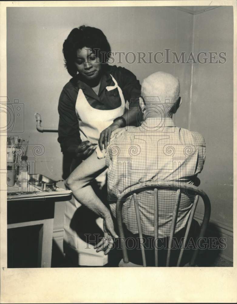 Load image into Gallery viewer, 1967 Press Photo Mrs. Melvin Jones, a nurse supervisor, gives shot to a patient
