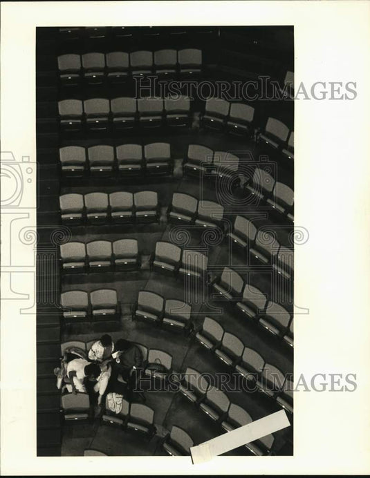 1984 Press Photo Three people have a section of seats during Hawks & Bucks game- Historic Images