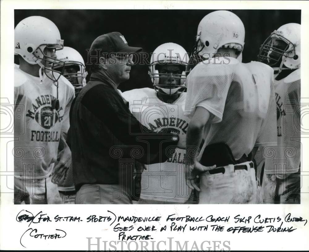 Press Photo Mandeville Football Cocah Skip Curtis goes over play during practice- Historic Images