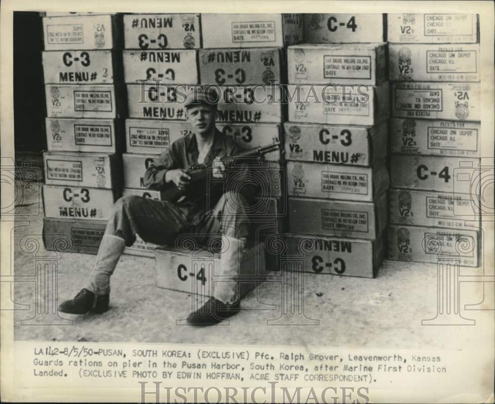 1950 Press Photo Pfc. Ralph Grover guards on pier in Pusan Harbor, South Korea.