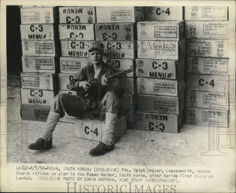 Load image into Gallery viewer, 1950 Press Photo Pfc. Ralph Grover guards on pier in Pusan Harbor, South Korea.

