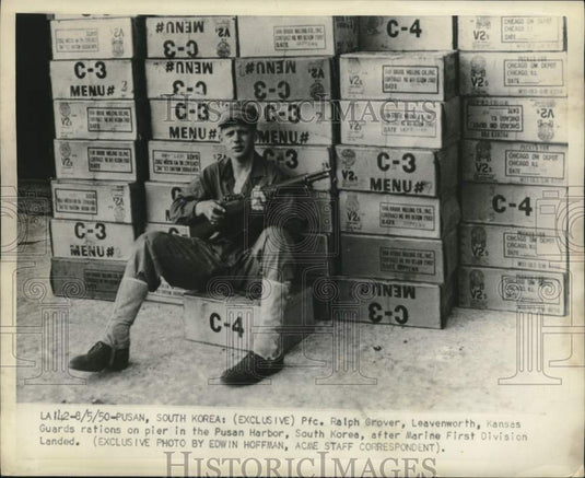 1950 Press Photo Pfc. Ralph Grover guards on pier in Pusan Harbor, South Korea.