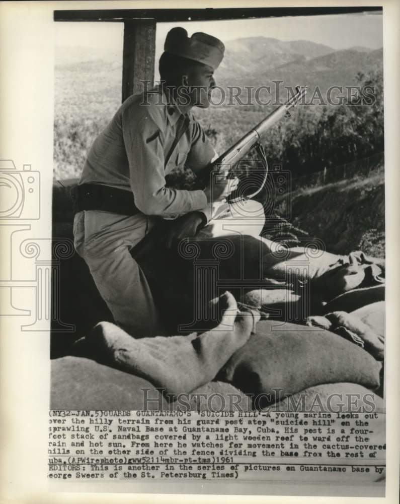 Load image into Gallery viewer, 1961 Press Photo Marine looks atop "Suicide Hill" at Guantanamo Bay, Cuba
