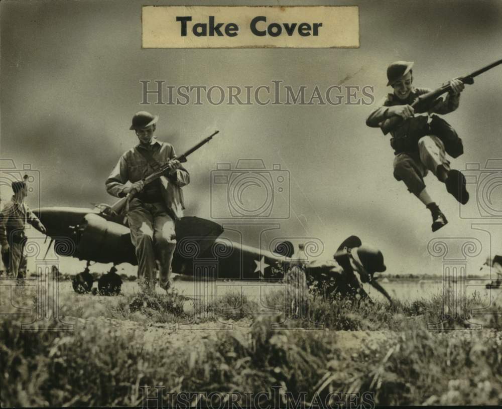 1947 Press Photo Troops run to occupy the foxholes at a U.S. airfield- Historic Images