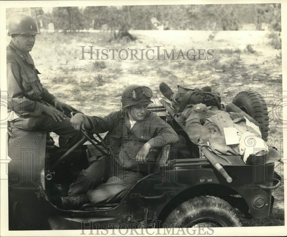 1951 Press Photo Jeep driver and soldier show how jeep can evacuate casualties.- Historic Images