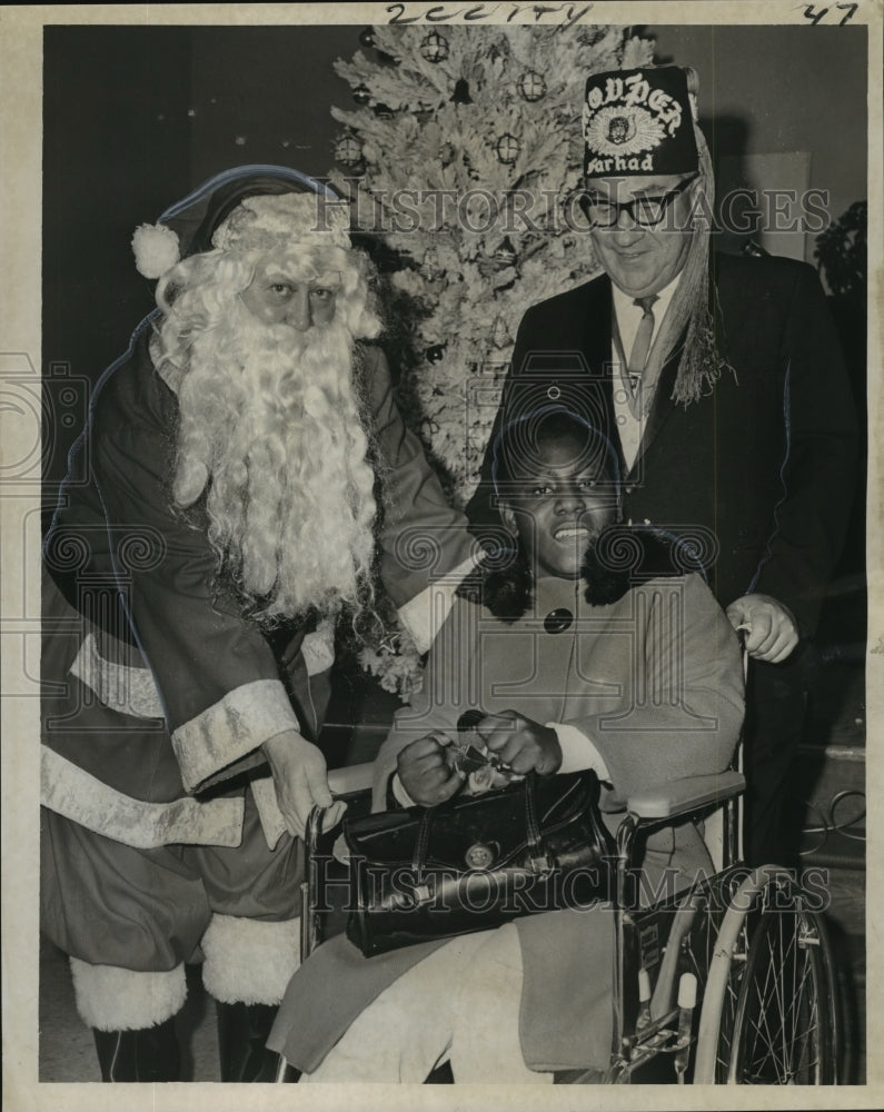 Load image into Gallery viewer, 1967 Press Photo Bernadette Washington Gets a Wheelchair from Santa Claus

