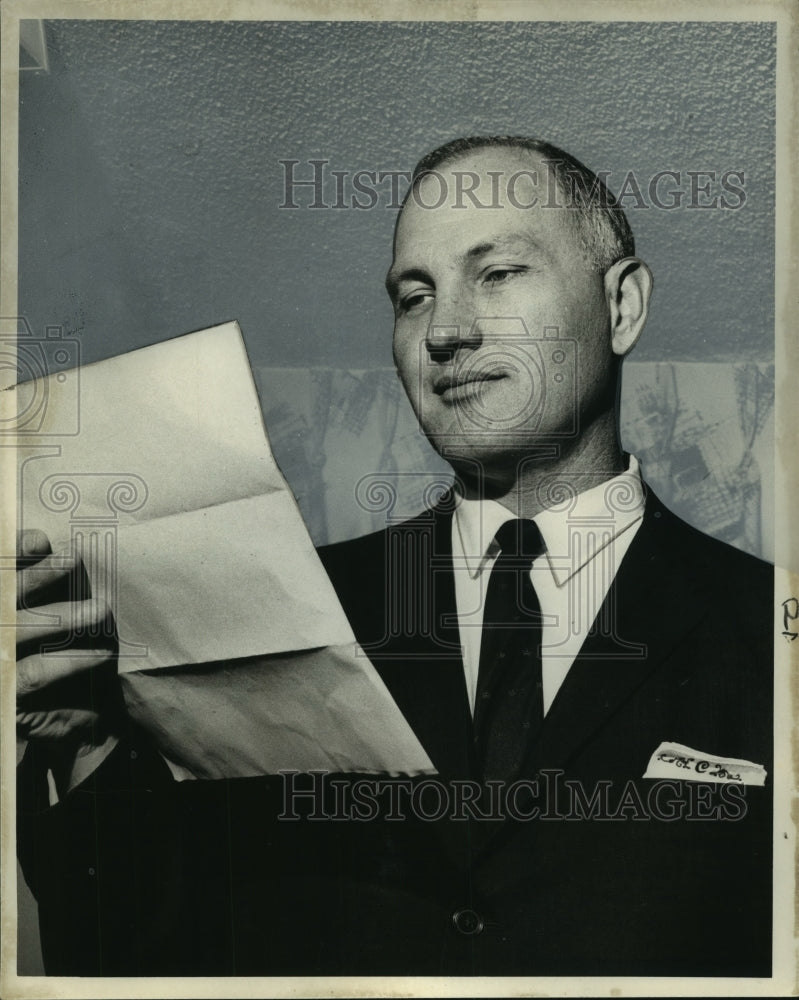 1966 Press Photo Sheriff Alwynn J. Cronvich Studies Circular About Shooting