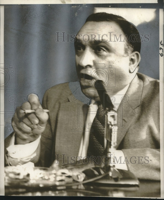 1957 Press Photo Anthony Doria answers financial operations questions