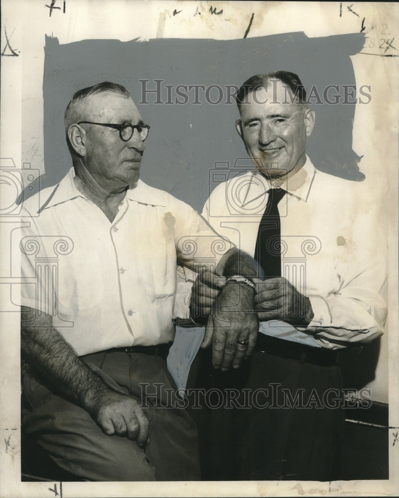 Load image into Gallery viewer, 1955 Press Photo Joseph Donnigan places a watch around Patrolman Paul Makarevich
