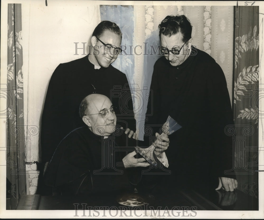 1957 Press Photo St. Rose of Lima Church priests examine parishioner heirlooms